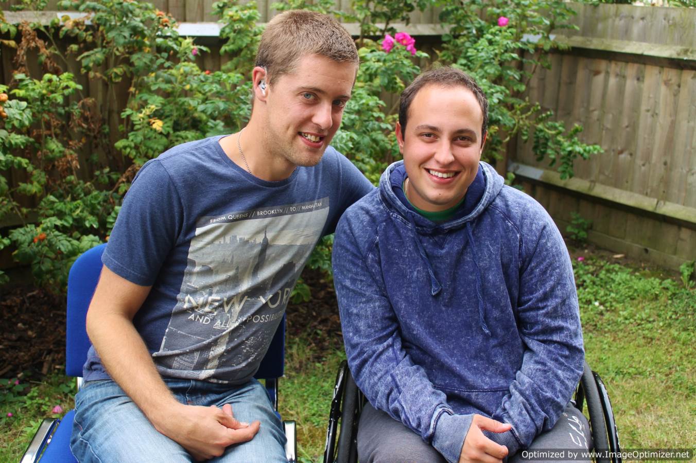 Two people sitting down and smiling